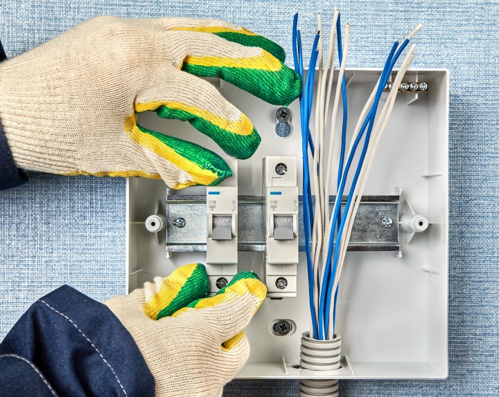 Technician installs a home fusebox or electrical consumer unit wiring panel northport ny