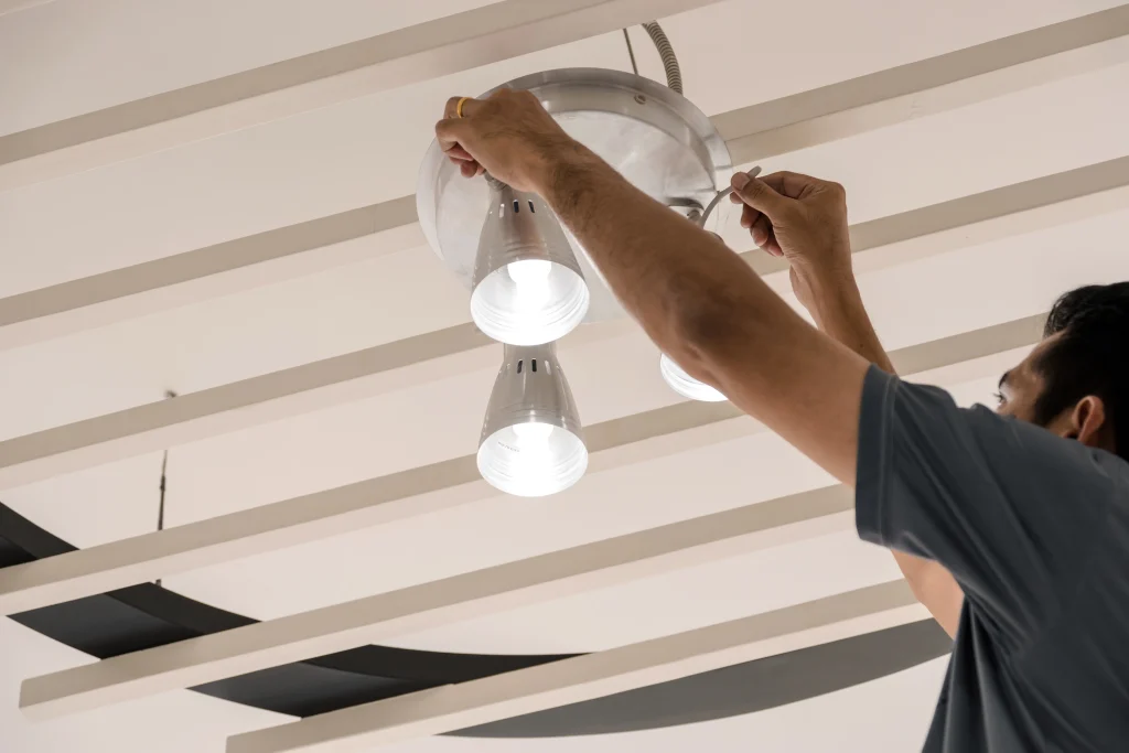 electrical engineers are installing ceiling lamps hallway